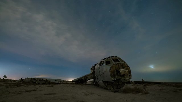 Astro Timelapse Tracking Shot of Moonrise over Abandoned B-52 in Desert