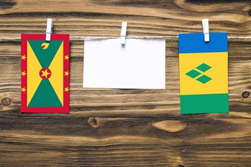Hanging flags of Grenada and Saint Vincent And The Grenadines attached to rope with clothes pins...