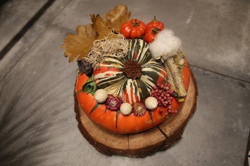 Decorative yellow pumpkin on wooden table.