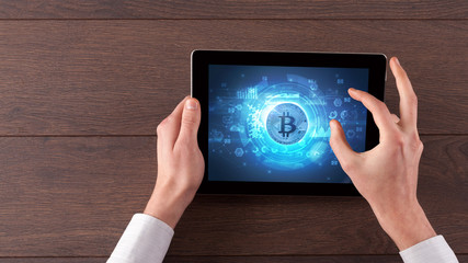 Hand working on tablet with cryptocurrency and network concept