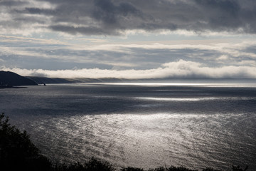 Obraz premium Mist and cloud over Cornwall flowing into the sea on the south Cornish cost in Whitsand bay