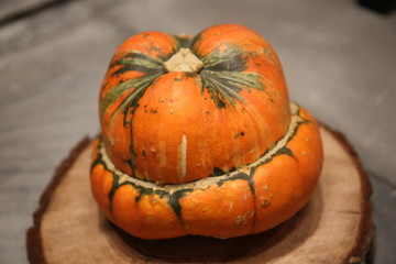 Decorative yellow pumpkin on wooden table.