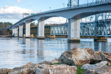View of bridge over Kennebec river in Bath, Maine On A Sunny Afternoon with light clouds in sky.