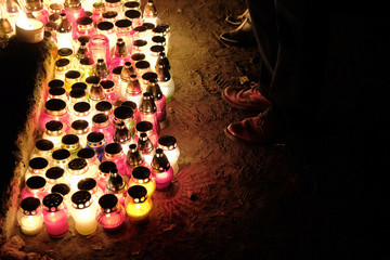 people remembering their loved ones who died during the war at a cemetery on all saints day in Poland