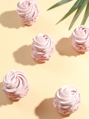 Hand made pink marshmallows on a beige background