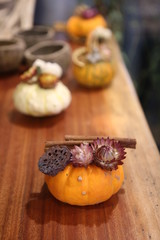 Decorative colorful pumpkins on wooden table.
