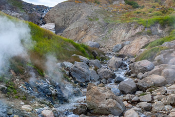 tourists going to the valley of geysers, soaring water from geysers, extreme tourism
