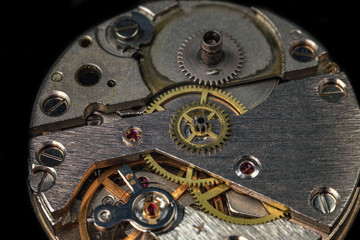 Fototapeta na wymiar vintage old mechanism with gears and springs, clock mechanism close-up macro