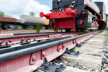 Naklejka premium rails for trains close-up selective focus, against the background of the train coming towards, safety on the railway, the danger of railway crossings