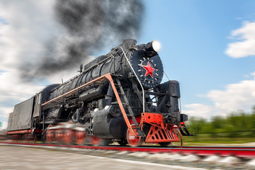 vintage steam train hurtling at speed along the rails, retro vehicle, steam engine