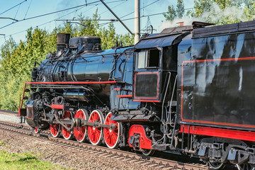 Fototapeta na wymiar Retro steam freight train departs from the railway station. Moscow. Russia.