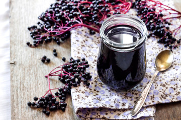 Homemade black elderberry syrup in glass jar