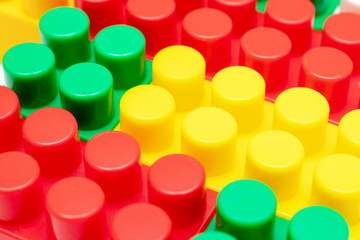 Colorful background made of toy plastic bricks, blocks for constructing and building by children
