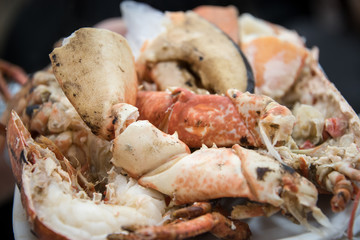 Chopped fried lobster on a white round dish..