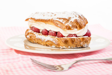 Raspberry Cream Eclair with strong Back Light on Dessert Dish with Pink Gingham Place Mat
