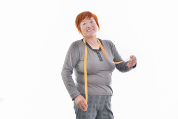 A woman with a measuring tape looking at the camera