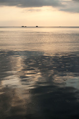 Fototapeta premium Calm sea at dawn with raindrops on the water surface, Koh Rong island, Cambodia.