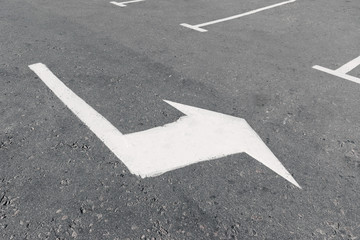 Road marking on asphalt with direction of movement
