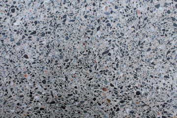Granite wall structure. Small multi-colored stones polished surface. Texture for design.