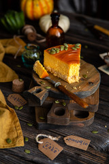 slice of pumpkin cheesecake with caramel sauce and seeds on top 
