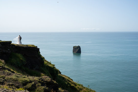 Wedding elopement happening on cliffs of the sea