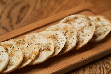Matzah - Jewish traditional Passover bread on wooden table.