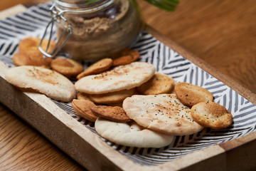 Homemade chicken liver pate in the jar on a wooden table, close-up.