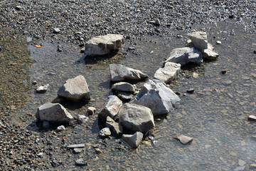 Natural small stones and cobblestones under water