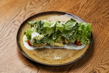 Dietary chicken salad with avocado, cucumber, arugula, cherry tomatoes