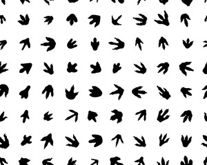 Fototapeta na wymiar Black trace of dinosaurs on white background, seamless vector wallpaper 