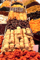 Dried fruits in the market. Raisins, bananas, dried apricots, dates, pineapples and prunes on the counter, on the market.
