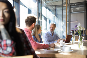 Casual business people having a meeting in a cafe