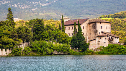 Fototapeta na wymiar Lake Toblino (Italy) - The Toblino lake is a special place with a unique landscape. On a promontory stands the Toblino Castle.