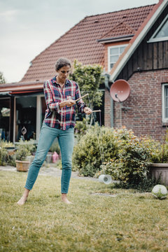Woman playing diadolo in her garden