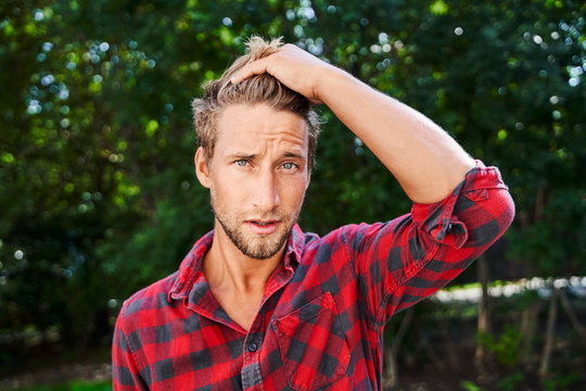 Portrait Of Young Man Wearing Checkered Shirt Outdoors