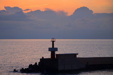 Fototapeta premium seascape with a lighthouse at sunset