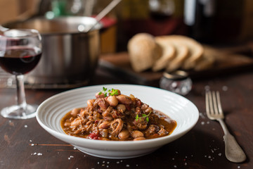 Hearty Bean Stew with Meat and Pepper in White Plate