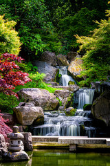 Waterfall long exposure vertical view with maple trees in Kyoto Japanese green Garden in Holland Park green summer zen lake pond water in London, UK - obrazy, fototapety, plakaty
