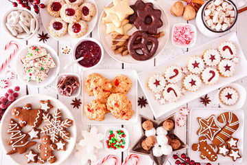 Christmas sweets and cookies. Top view table scene over a white wood background. Holiday baking...
