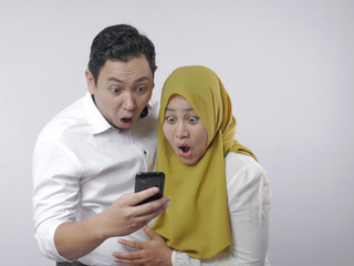 Muslim Couple Shocked Surprised Looking at Smart Phone