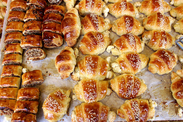 Small rolls with poppy seeds and kunzhet on the market. The market in Jerusalem.