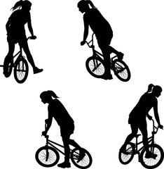 Fototapeta premium silhouette of girl doing bike trick on BMX bicycle