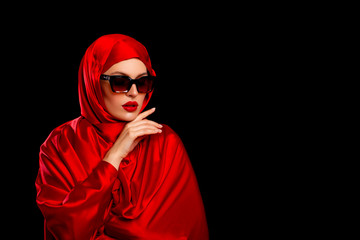 Beautiful Luxury Girl in Red Hijab. isolated. Red Lips. Fashionable young Arabic  Woman in sun-protected glasses. Bride. Arab Traditions. Beautiful Arab Girl on black background