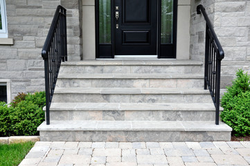 Flagstone applied to the original concrete veranda, natural stone steps, and a tumbled paver...