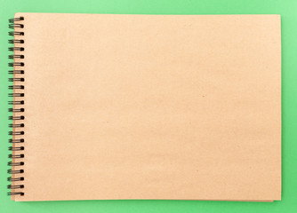 Empty sketchbook on green background, mock up, top view