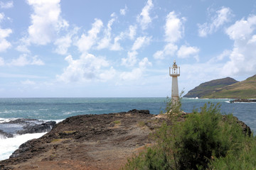 Fototapeta na wymiar Lighthouse set on Kukii Point near the inlet to the bay