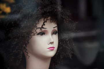 Closeup of afro wig on mannequin in fashion store showroom