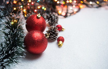 Christmas decoration with balls on snow with copy space
