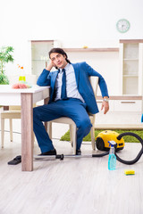 Young businessman cleaning the house