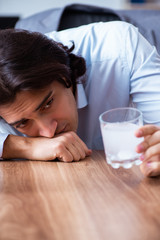 Sick male employee suffering in the office